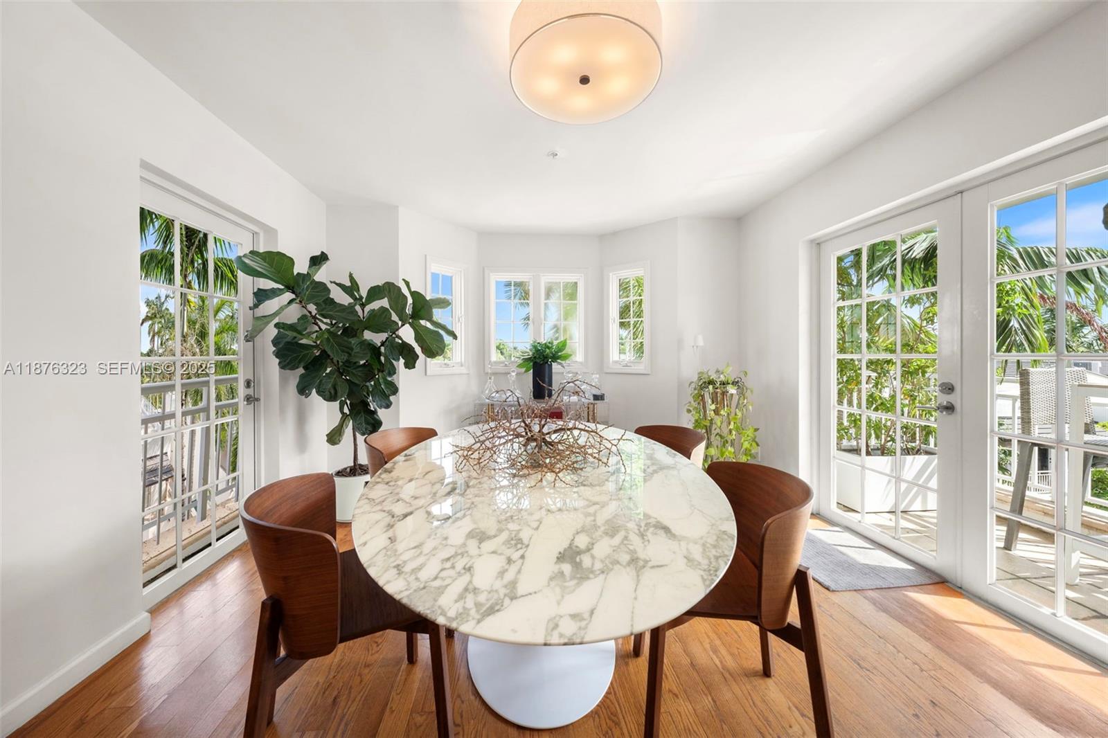 1415 Sunset Harbour Drive, Unit 406 Miami Beach, FL 33139 - Photo 8 of 83 a view of a dining room with furniture window and wooden floor