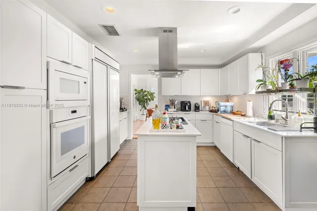 a kitchen with a sink window and cabinets