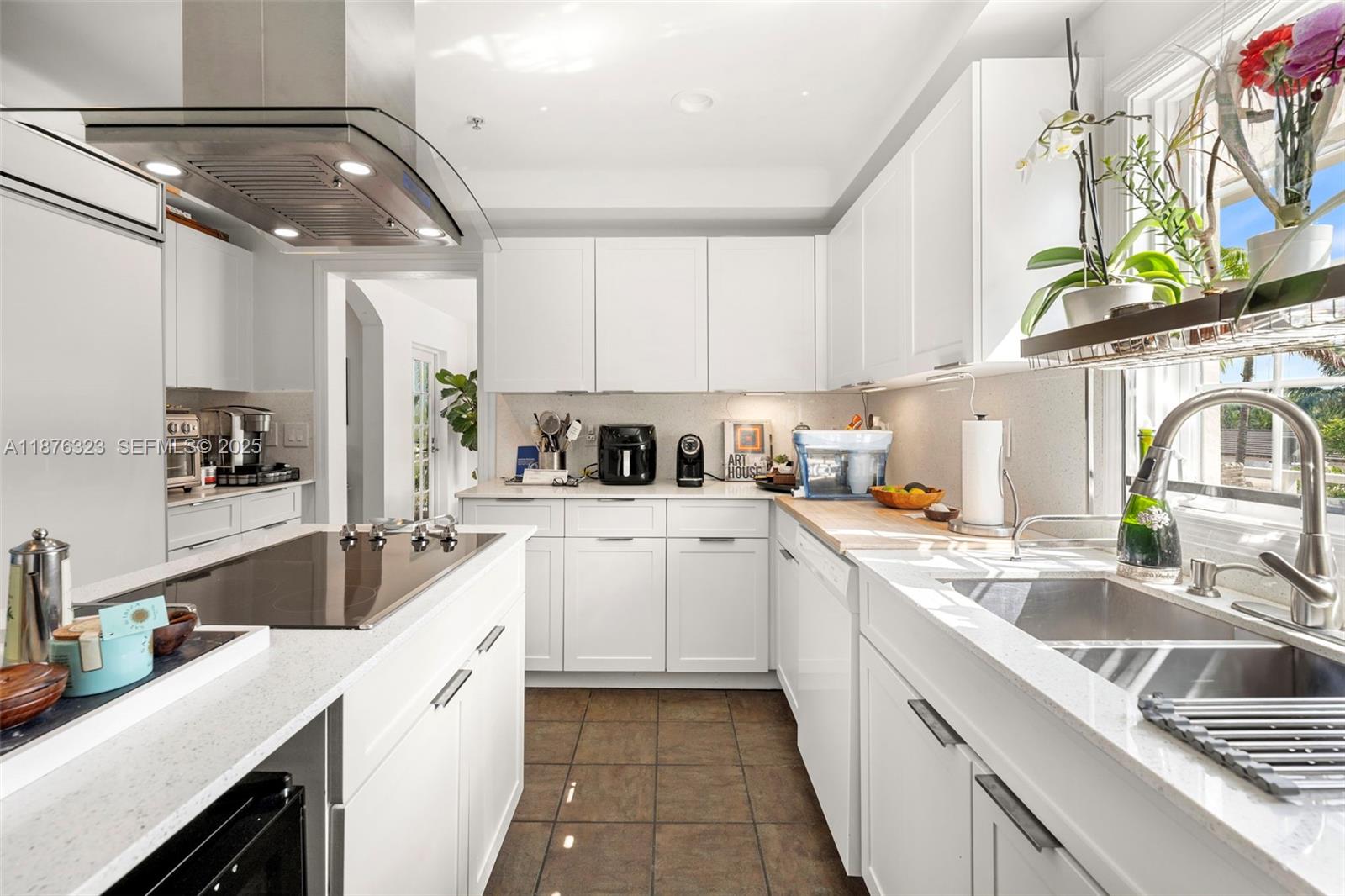 1415 Sunset Harbour Drive, Unit 406 Miami Beach, FL 33139 - Photo 10 of 83 a kitchen with a sink cabinets and window