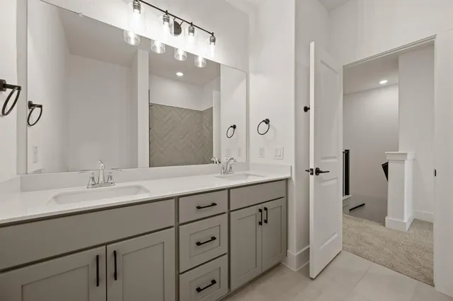 a bathroom with a double vanity sink and mirror