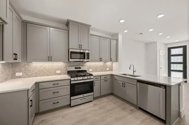 a view of appliances with cabinets