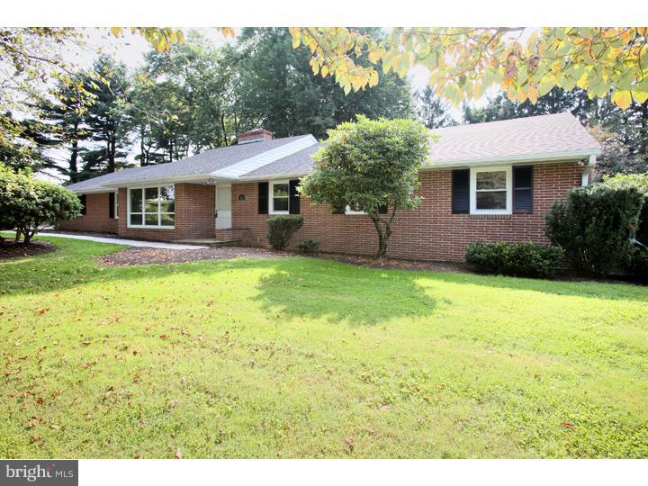 123 Sharp Road Avondale, PA 19311 - Photo 1 of 24 a front view of a house with a garden