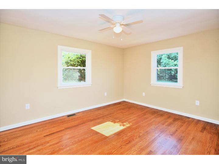 123 Sharp Road Avondale, PA 19311 - Photo 14 of 24 an empty room with wooden floor and windows
