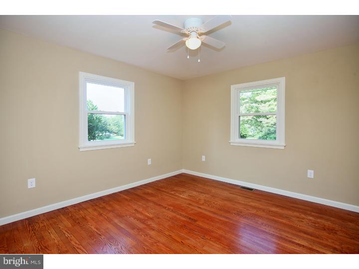 123 Sharp Road Avondale, PA 19311 - Photo 17 of 24 an empty room with wooden floor and windows