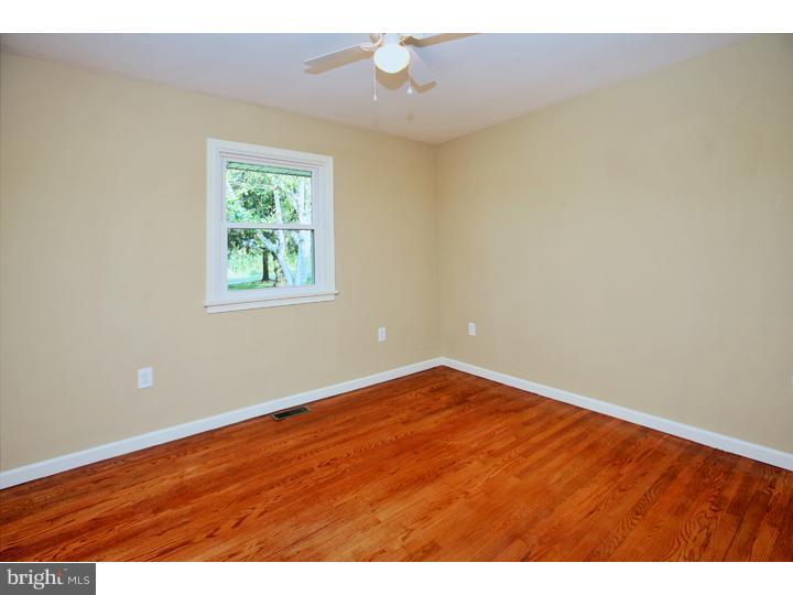 123 Sharp Road Avondale, PA 19311 - Photo 18 of 24 an empty room with wooden floor and windows