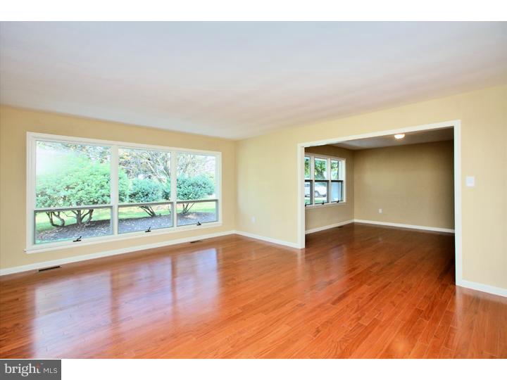 123 Sharp Road Avondale, PA 19311 - Photo 3 of 24 a view of an empty room with wooden floor and a window