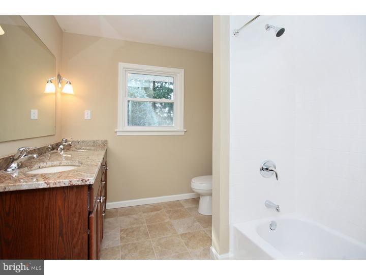 123 Sharp Road Avondale, PA 19311 - Photo 21 of 24 a bathroom with a granite countertop sink a toilet a shower and a mirror