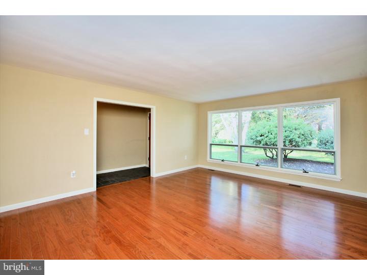 123 Sharp Road Avondale, PA 19311 - Photo 4 of 24 a view of an empty room with wooden floor and a window