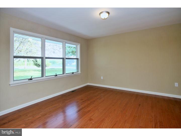 123 Sharp Road Avondale, PA 19311 - Photo 6 of 24 an empty room with wooden floor and windows
