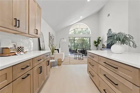 a spacious bathroom with double vanity and a window