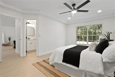 a bedroom with a bed and a large window