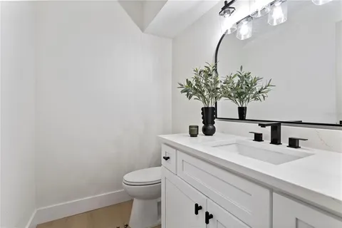a bathroom with a sink a toilet and mirror