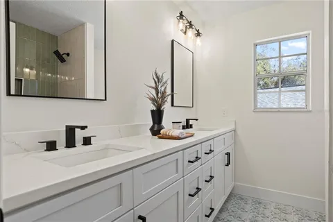 a bathroom with a double vanity sink mirror and