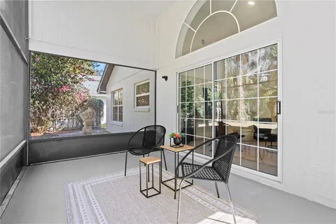 a view of a yard with plants and trees