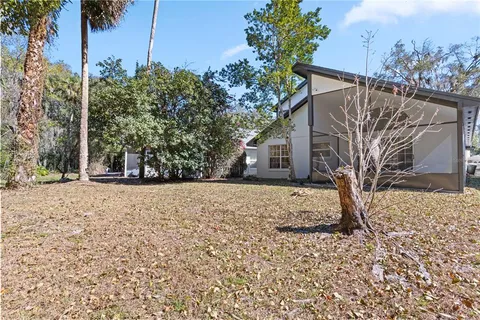 a backyard of a house with large trees