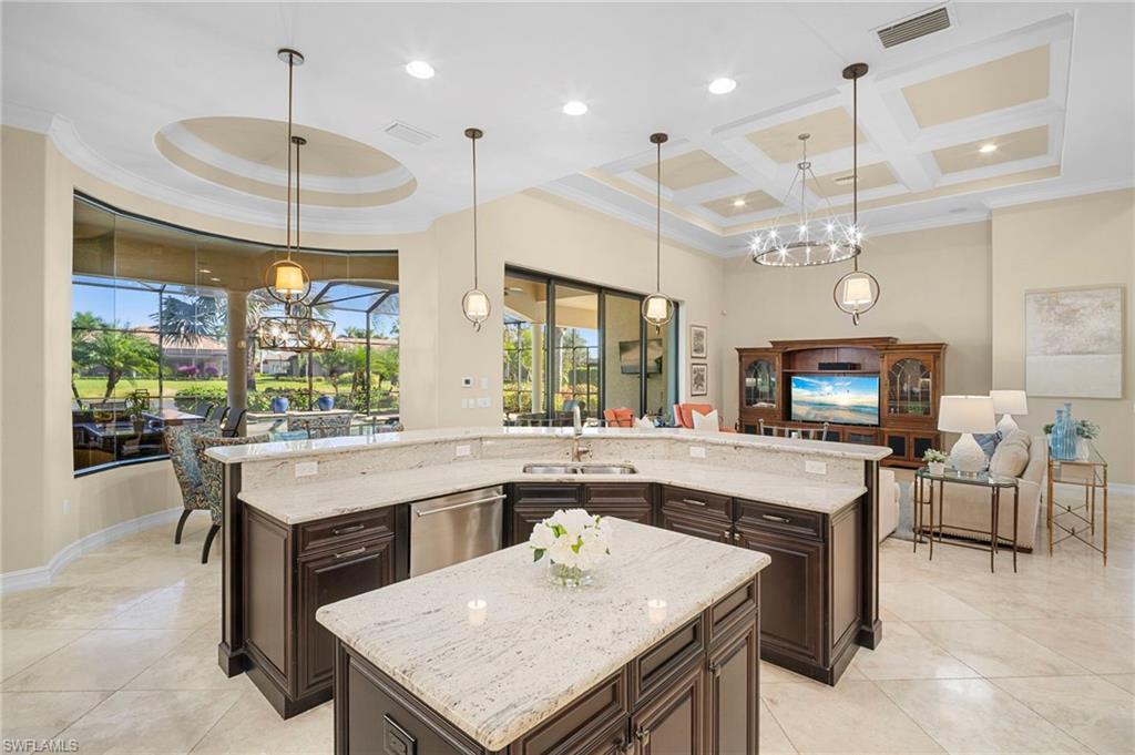 6482 Carema Lane Naples, FL 34113 - Photo 11 of 40 a large kitchen with a table and chairs