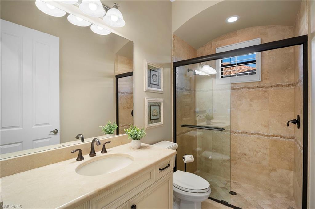 6482 Carema Lane Naples, FL 34113 - Photo 25 of 40 a bathroom with a sink a toilet and shower