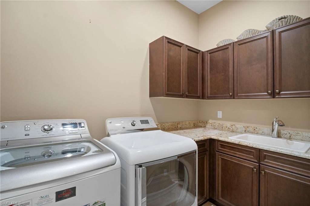 6482 Carema Lane Naples, FL 34113 - Photo 27 of 40 a utility room with dryer and washer