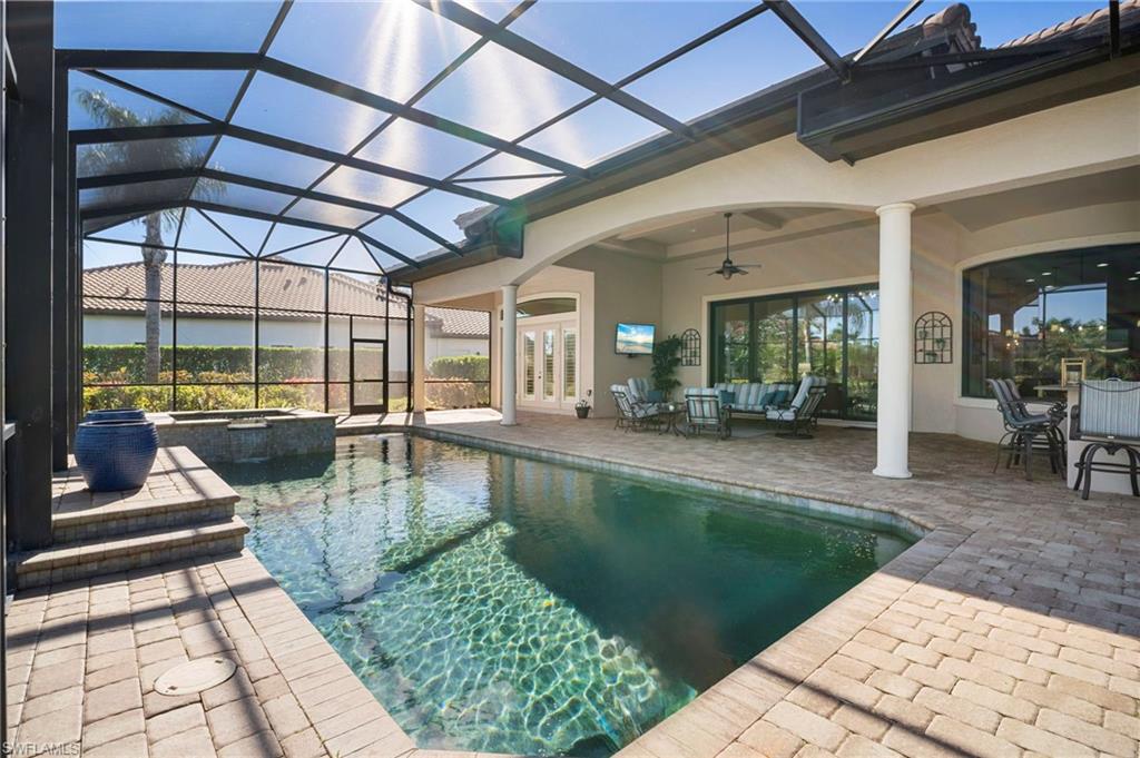 6482 Carema Lane Naples, FL 34113 - Photo 33 of 40 a view of a swimming pool with a patio