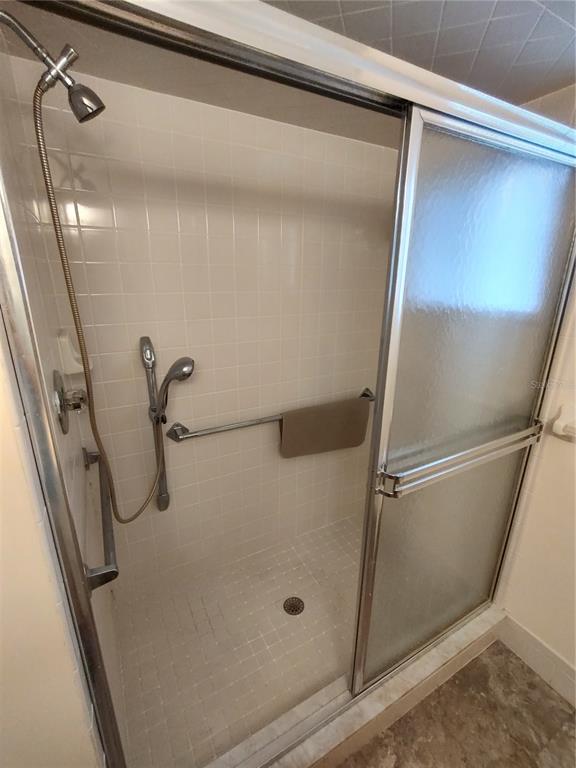 6345 Southwest 115th Street Road Ocala, FL 34476 - Photo 8 of 10 a bathroom with a glass shower door