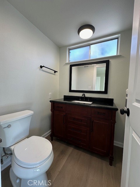 6952 Platt Avenue West Hills, CA 91307 - Photo 11 of 14 a bathroom with a toilet a sink and a mirror