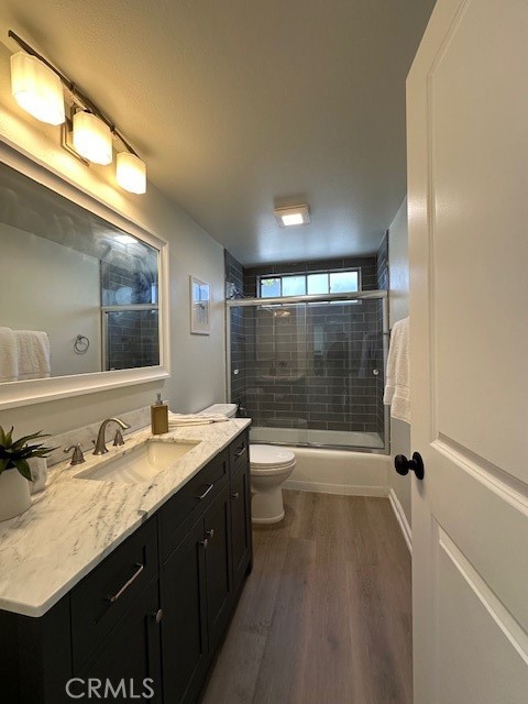 6952 Platt Avenue West Hills, CA 91307 - Photo 10 of 14 a bathroom with a granite countertop sink a toilet a mirror and shower