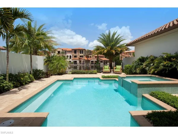 a swimming pool with outdoor seating and yard