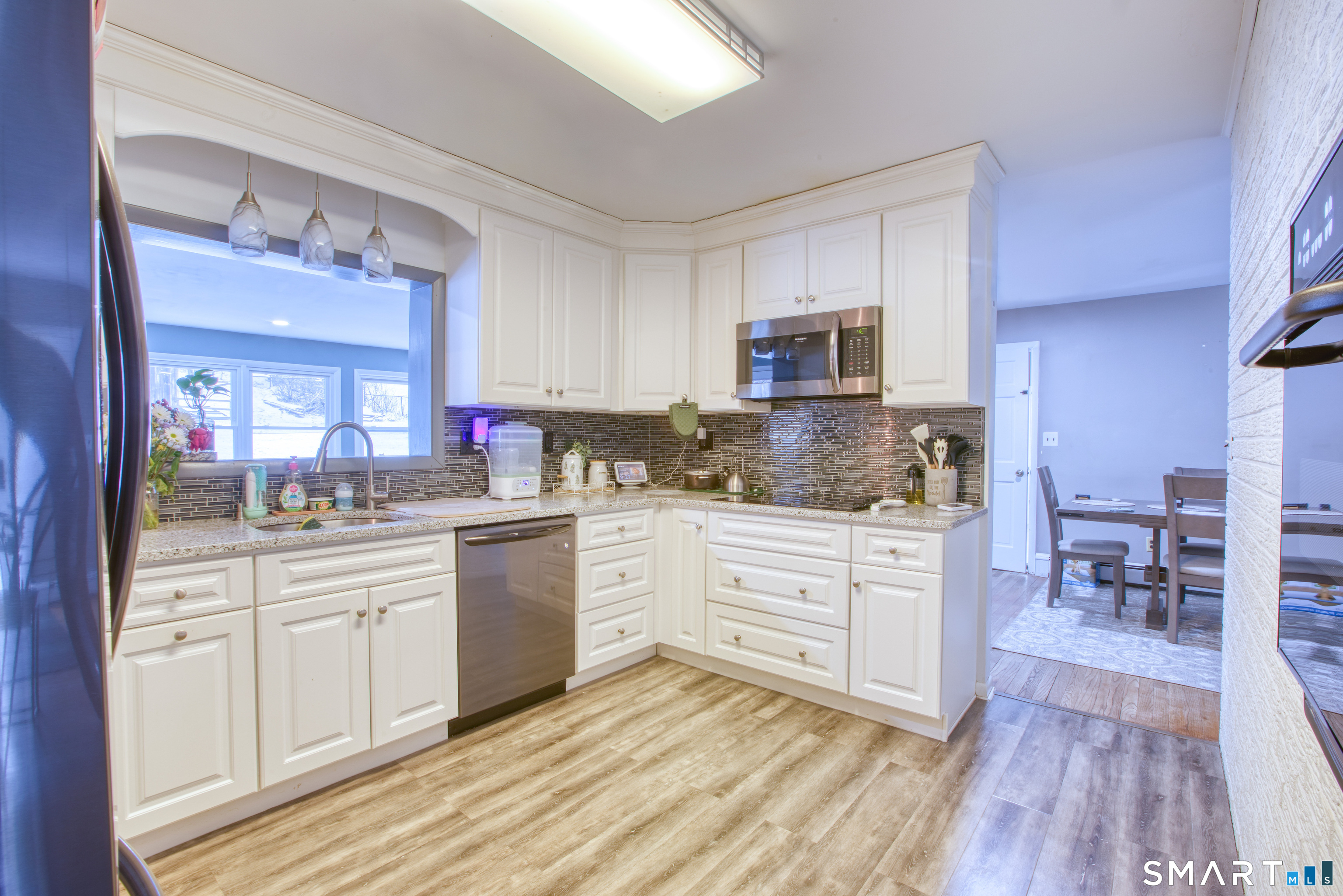 4 Edmond Road Bethel, CT 06801 - Photo 11 of 40 a kitchen with cabinets stainless steel appliances a sink and a stove