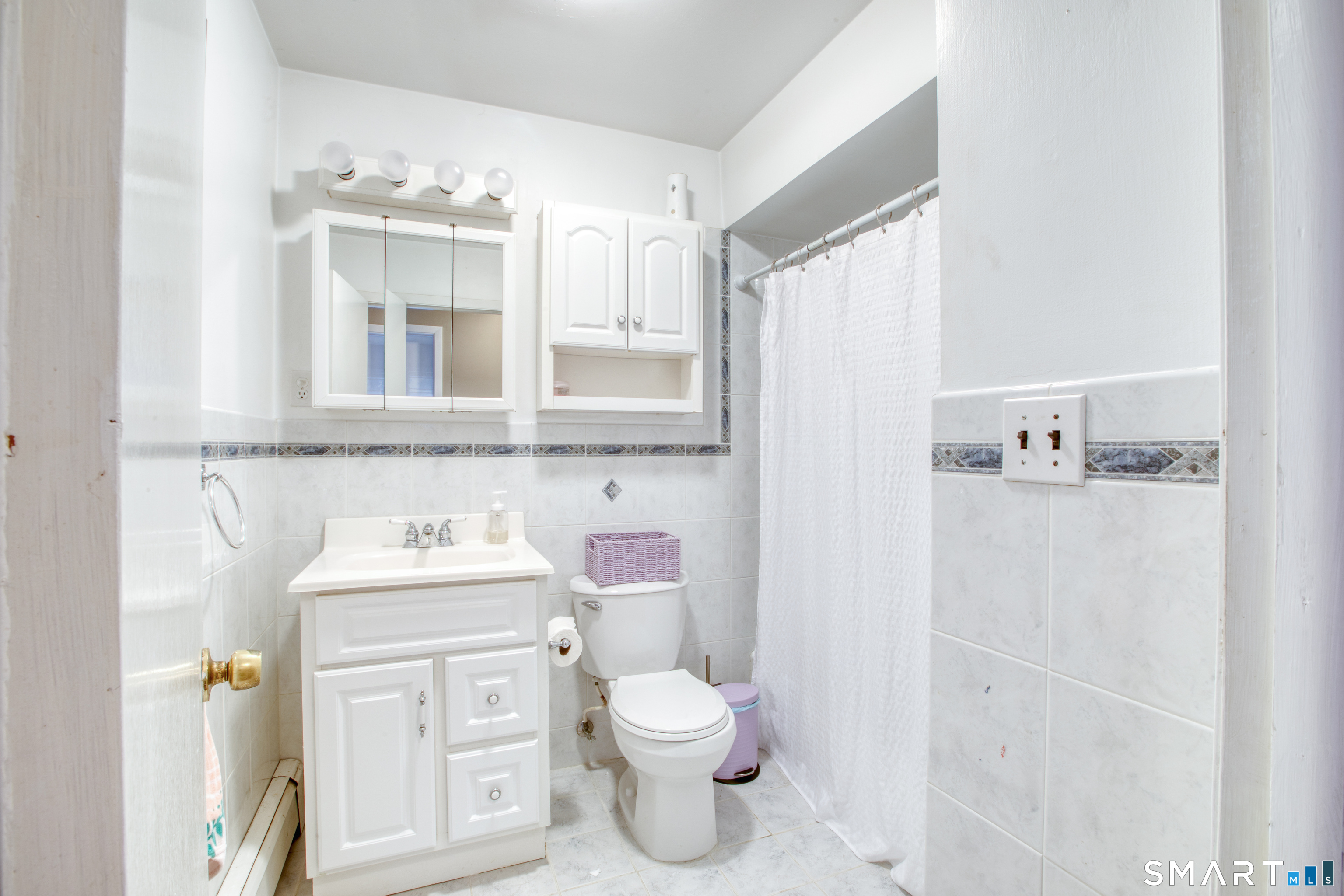 4 Edmond Road Bethel, CT 06801 - Photo 14 of 40 a bathroom with a toilet sink and mirror