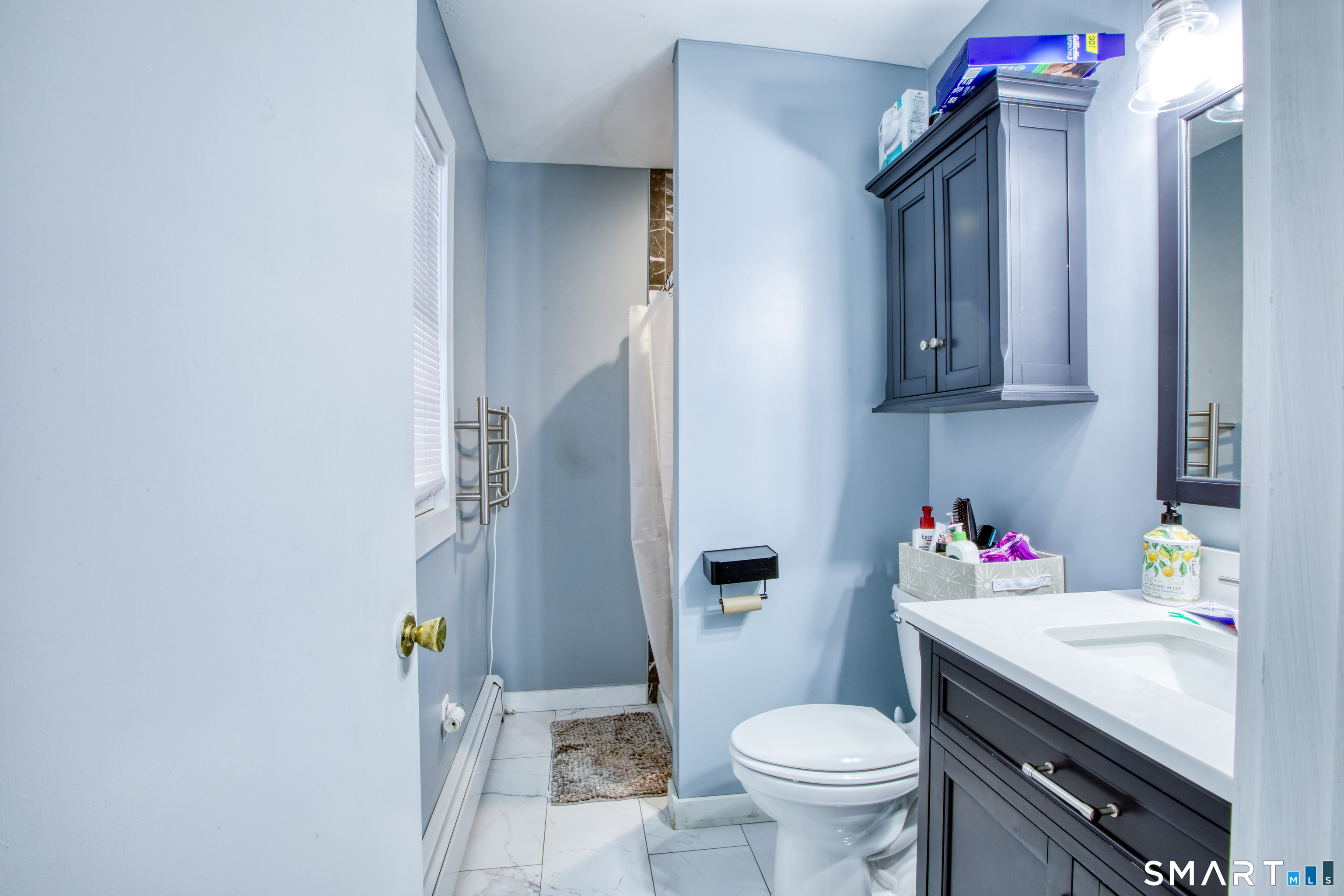4 Edmond Road Bethel, CT 06801 - Photo 16 of 40 a bathroom with a toilet sink and mirror