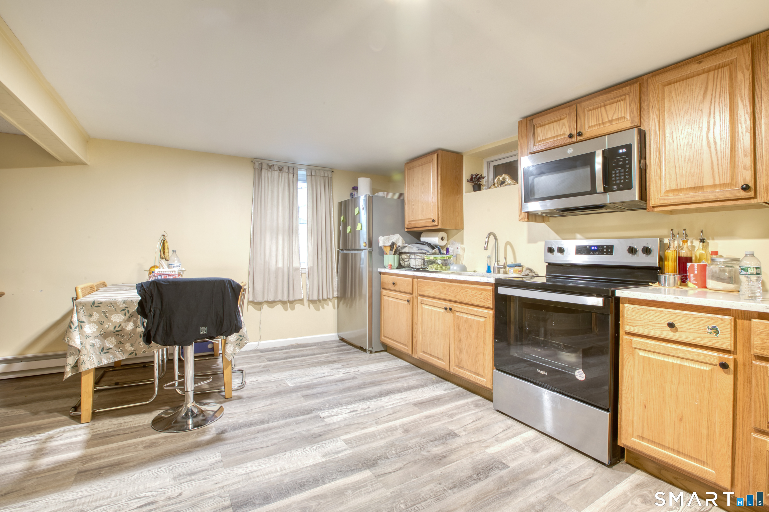 4 Edmond Road Bethel, CT 06801 - Photo 32 of 40 a kitchen with stainless steel appliances granite countertop a stove top oven a sink dishwasher and white cabinets with wooden floor