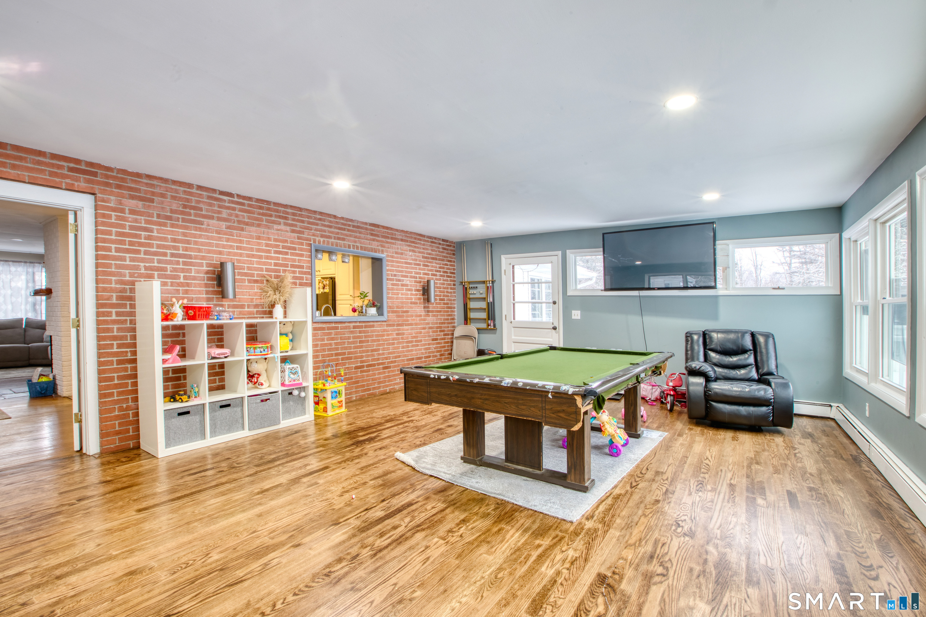 4 Edmond Road Bethel, CT 06801 - Photo 9 of 40 a living room with a wooden floor and pool table