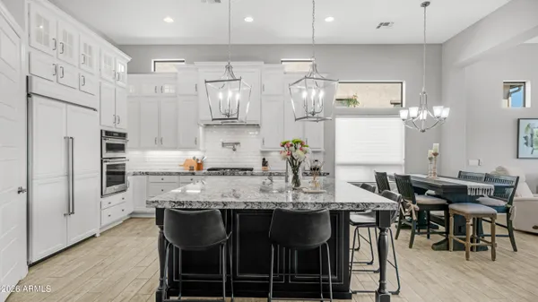a view of a dining room with furniture and chandelier