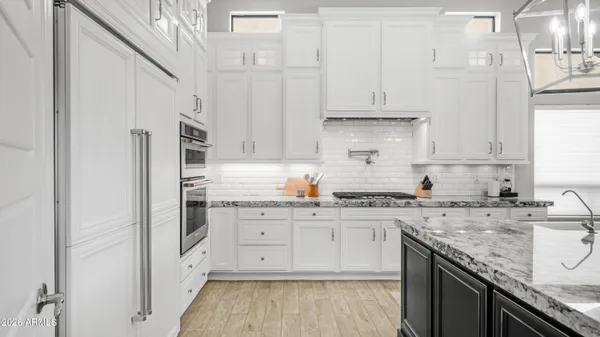 a bathroom with a granite countertop shower a sink and a mirror