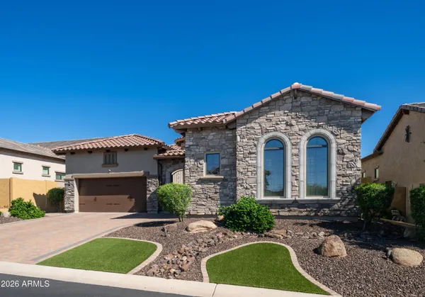 a kitchen with stainless steel appliances granite countertop a kitchen island a stove a table and chairs in it