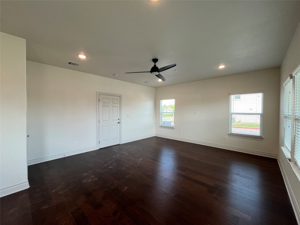 2105 Tiger Trail, Unit 501 Round Rock, TX 78664 - Photo 4 of 10 an empty room with wooden floor and windows