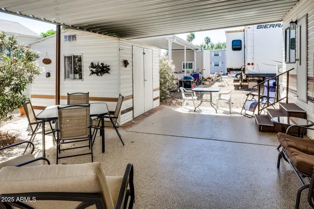 a view of a patio with table and chairs potted plants with wooden floor