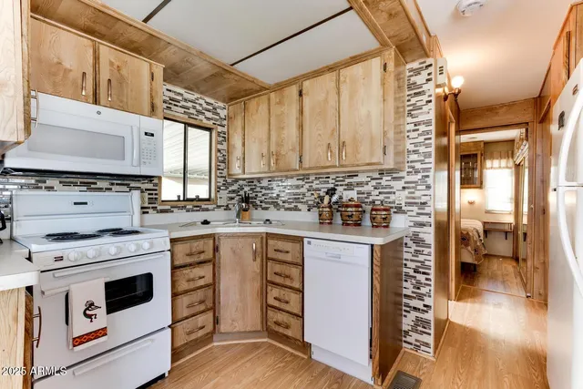 a kitchen with stainless steel appliances granite countertop a stove and cabinets