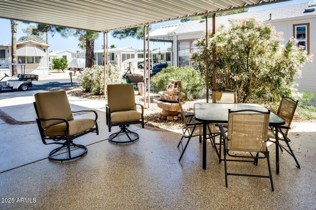 a living room with patio furniture and a potted plant