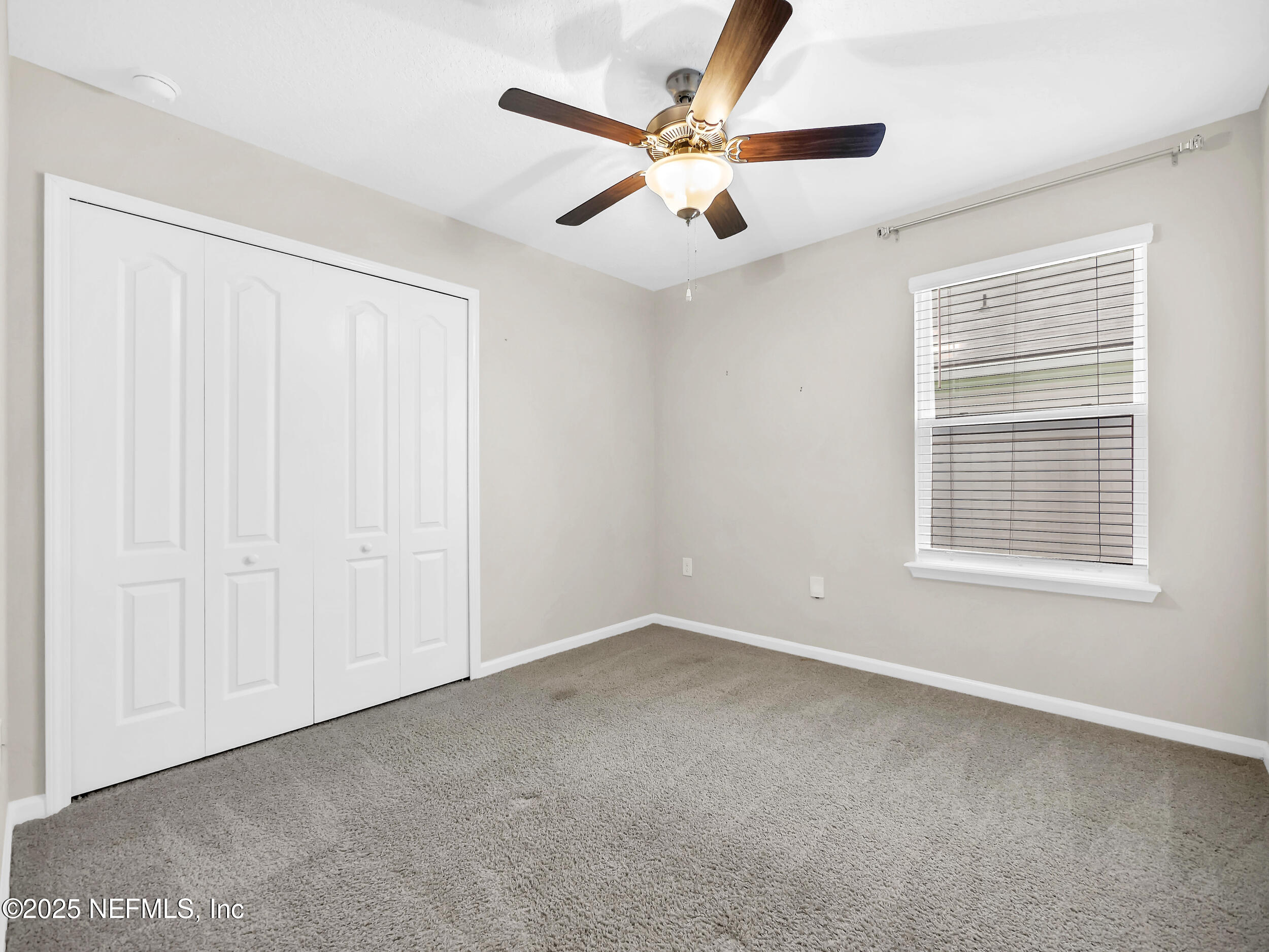 258 Fox Water Trail St. Augustine, FL 32086 - Photo 14 of 50 an empty room with fan and windows