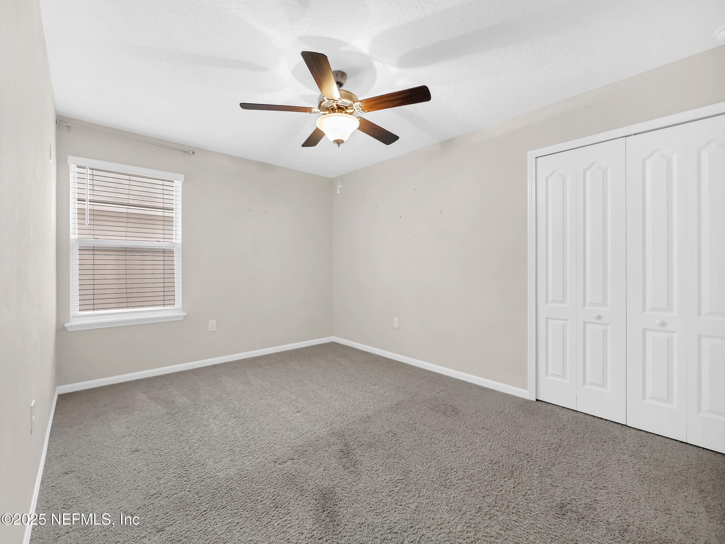 258 Fox Water Trail St. Augustine, FL 32086 - Photo 16 of 50 an empty room with windows and fan