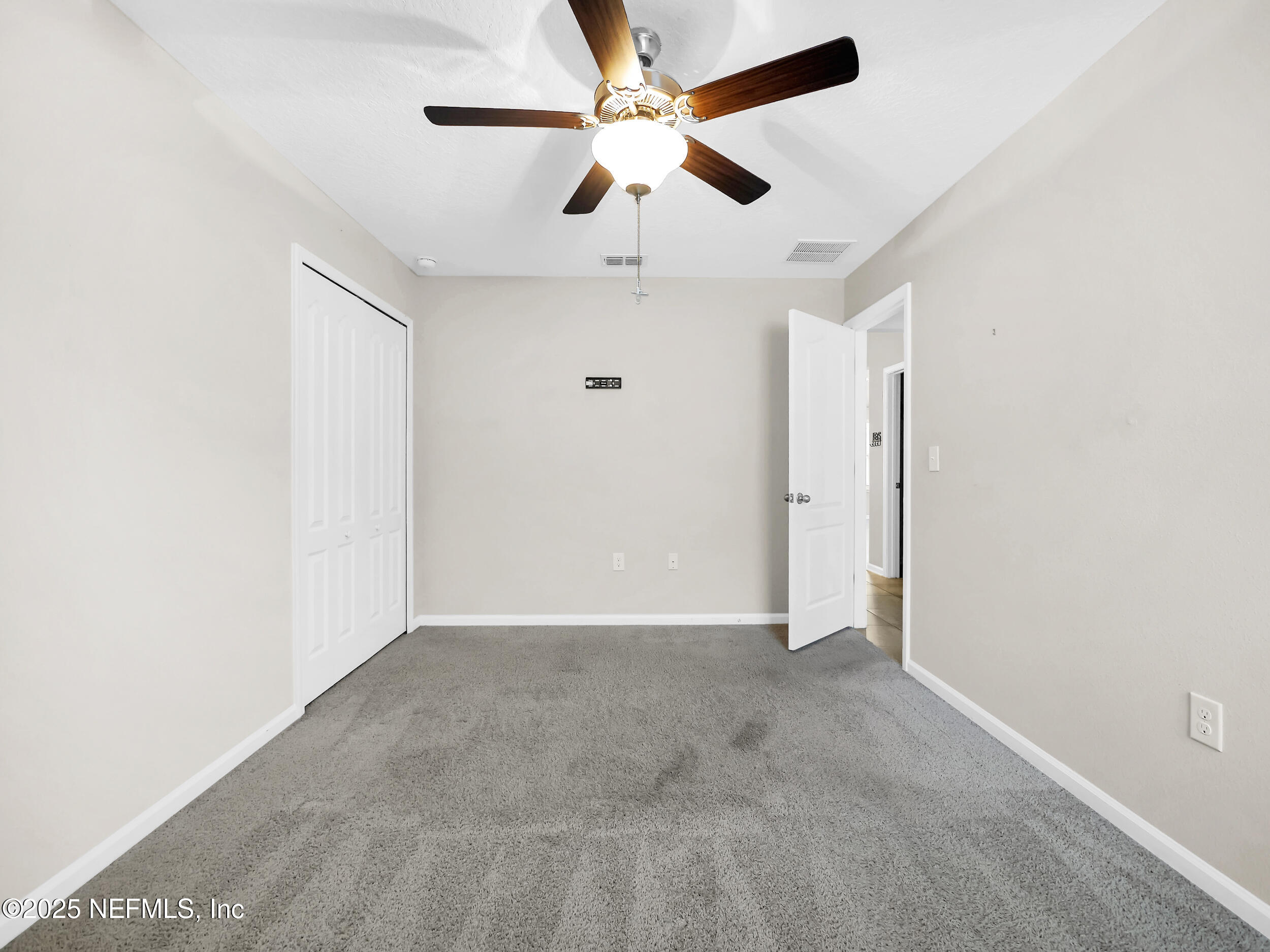 258 Fox Water Trail St. Augustine, FL 32086 - Photo 18 of 50 an empty room with ceiling fan and window