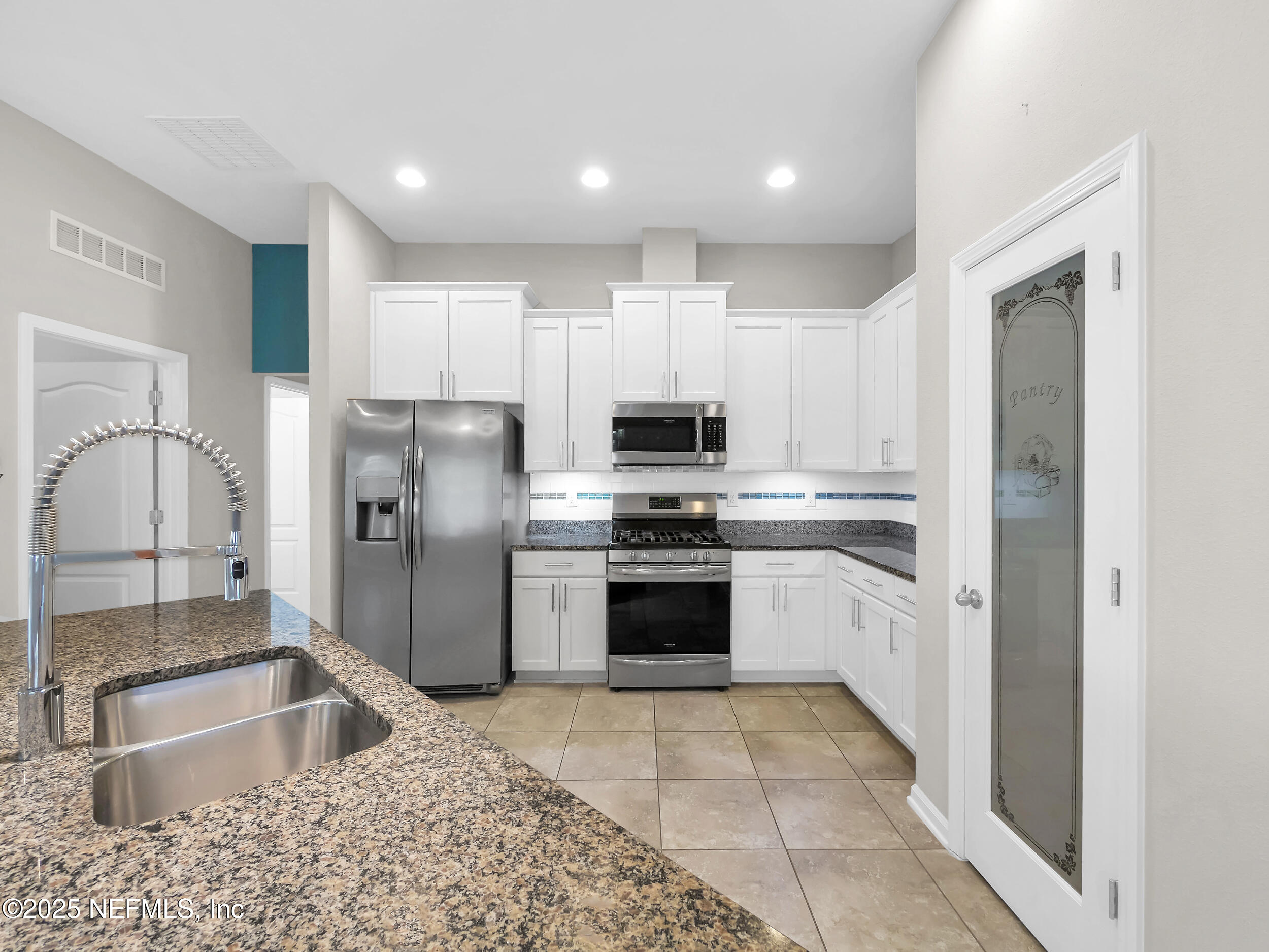 258 Fox Water Trail St. Augustine, FL 32086 - Photo 19 of 50 a kitchen with stainless steel appliances granite countertop a refrigerator and a sink