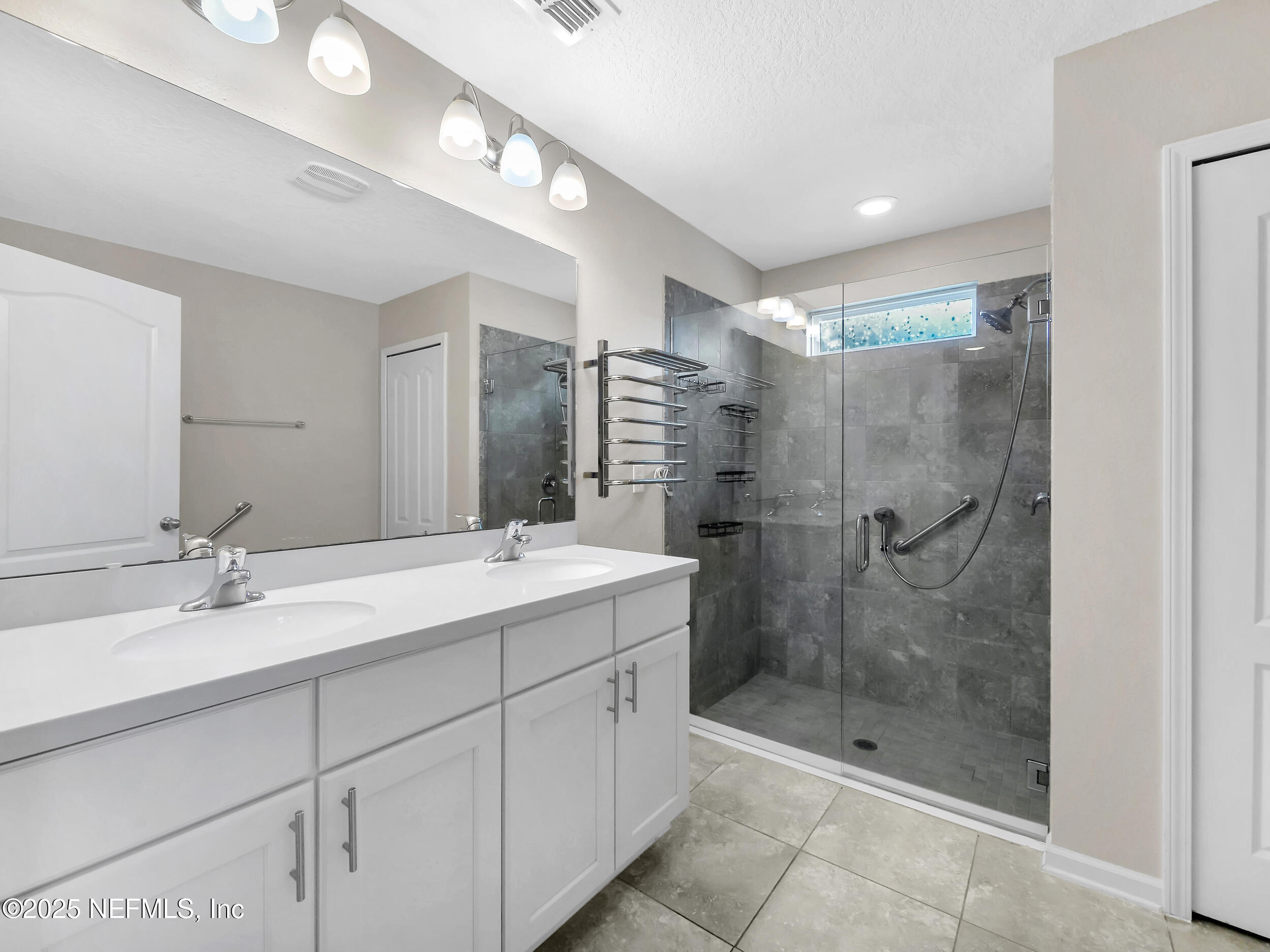 258 Fox Water Trail St. Augustine, FL 32086 - Photo 28 of 50 a bathroom with a shower sink and mirror