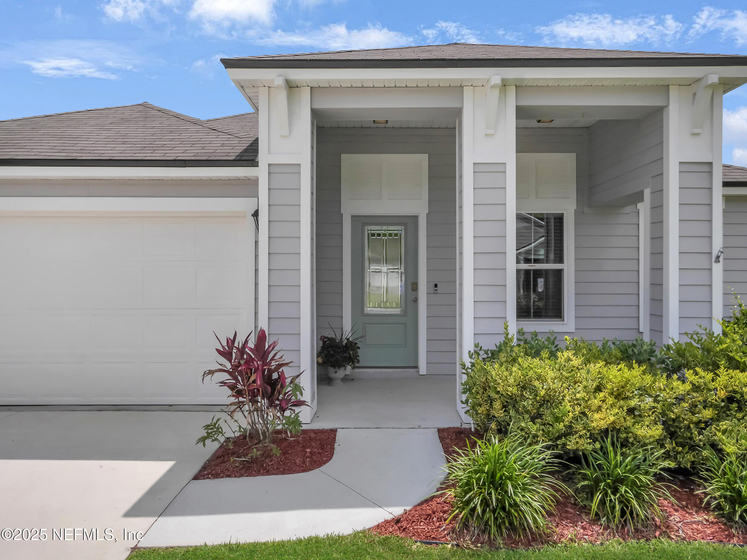 258 Fox Water Trail St. Augustine, FL 32086 - Photo 4 of 50 a potted plant in front of a house