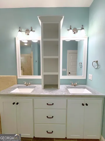 a bathroom with a sink and mirror