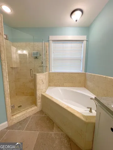 a bathroom with a bathtub and shower