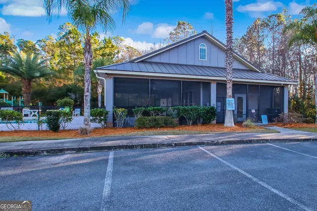 a front view of a house with a yard and a garage