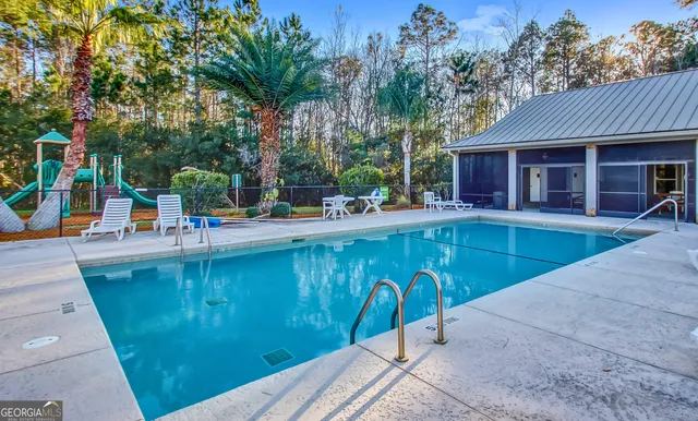swimming pool view with a seating space