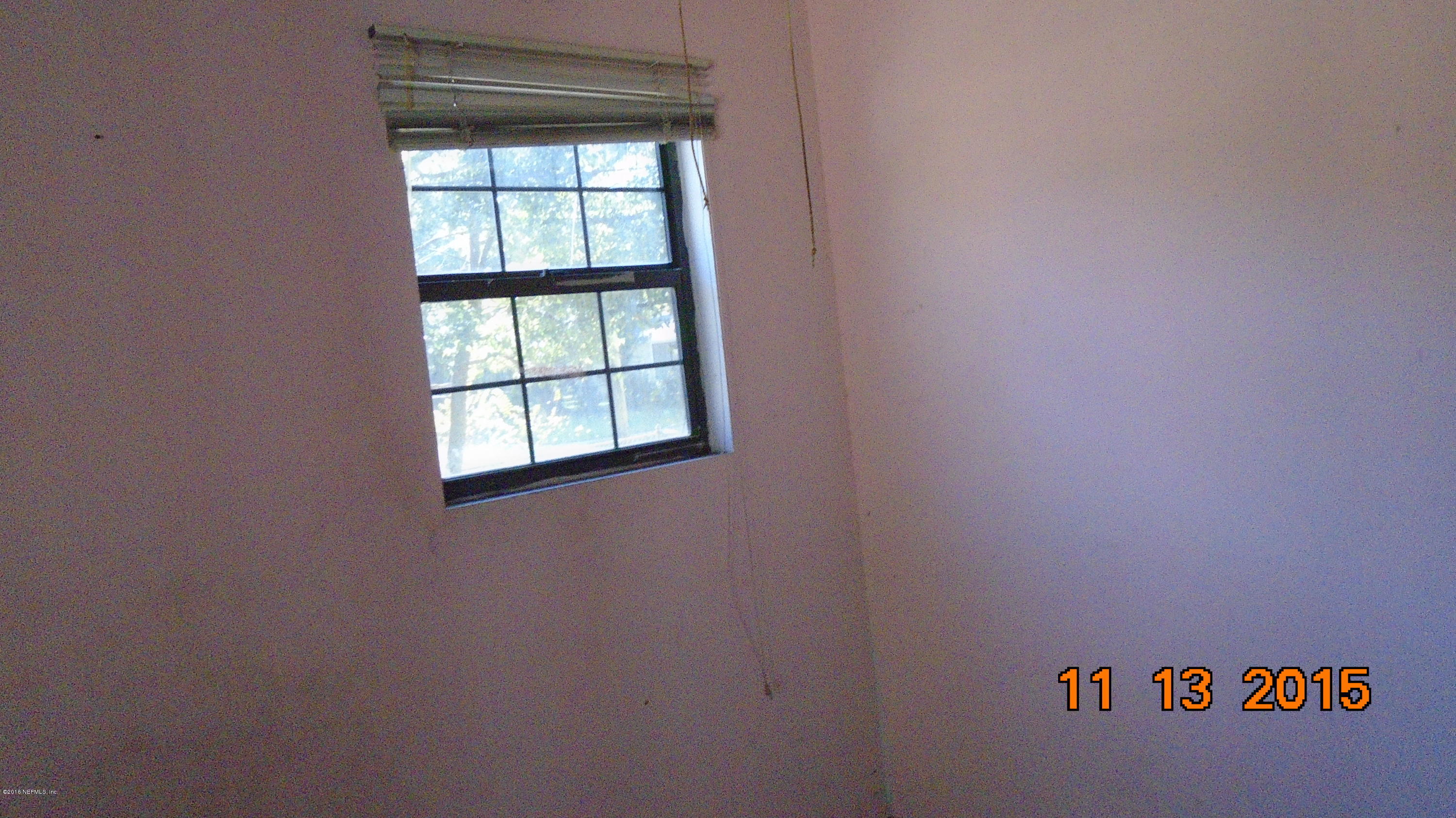 2049 Benedict Road Jacksonville, FL 32209 - Photo 5 of 6 an empty room with a window